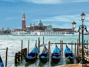  ??  ?? Opening image: Riva degli Schiavoni in Venice.
Clockwise from below left: River Countess sailing past the Church of San Giorgio Maggiore in the heart of Venice; Rack of lamb from the River Countess’ restaurant; The lounge on River Countess.
Far...