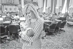  ?? RODNEY WHITE/USA TODAY NETWORK ?? Rep. Megan Jones feeds her daughter Alma after voting in the Iowa Statehouse on Feb. 20 in Des Moines.