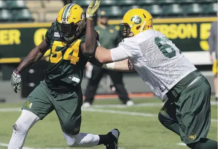  ?? DAVID BLOOM ?? Defensive end Alex Bazzie, left, was practising on Eskimos teammate Colin Kelly the pass rush moves he’ll use on former B.C. Lions teammate Jonathan Jennings when the teams meet at Commonweal­th Stadium.