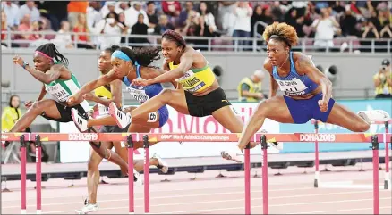  ??  ?? Nia Ali, of the United States (right), wins the gold medal in the women’s 100 meter hurdles final at the World Athletics Championsh­ips in Doha, Qatar on
Oct 6. At left is Kendra Harrison, of the United States, silver, and Danielle Williams, of Jamaica, bronze. (AP)