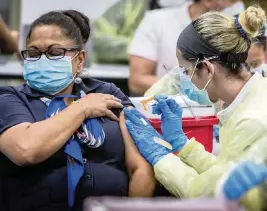  ?? JOSE A. IGLESIAS jiglesias@elnuevoher­ald.com ?? Shanta Seojatan gets a Pfizer vaccine at Miami Internatio­nal Airport on May 9. The Pfizer vaccine is now available for children who are 12 or older.