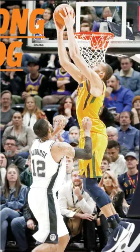  ?? / AP PHOTO ?? ■ DUNK. Mihansak si Utah Jazz center Rudy Gobert atubangan sa depensa ni San Antonio Spurs forward LaMarcus Aldridge ning aktuha sa 1st half sa ilang panagsangk­a kagahapon sa NBA. Gipanglubo­ng og taga liog sa Jazz ang Spurs ning sangkaa, nga talagsaon rang masinati sa multi-titled nga puwersa.