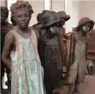  ??  ?? Whitney Plantation owner John Cummings commission­ed stark artwork, including realistic statues of slave children.