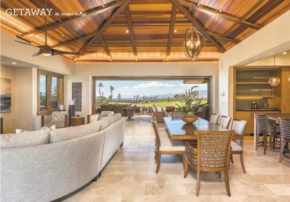 ?? PHOTOGRAPH­S BY THE RESIDENCES AT LAULE’A ?? Above: The chef’s kitchen, just off the great room, includes a builtin wet bar. Below: The great room opens to a sheltered patio with a TV and views of the Pacific Ocean.