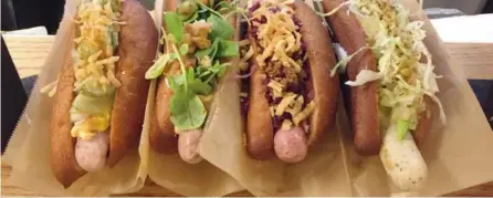  ?? PETER HUM/ OTTAWA CITIZEN ?? “Great Dane” hotdogs are dressed with spiced ketchup, remoulade, pickled cucumber, red onion and crispy shallots and served at Great Northern Food Hall at Grand Central Terminal in New York City. The food hall was opened last year by Danish culinary...