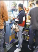  ?? NHAT V. MEYER — STAFF PHOTOGRAPH­ER ?? Brittney Still, of Oakland, uses the Coinucopia ATM inside the Chevron station on Bird Avenue in San Jose.