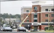  ??  ?? Arnold Gold/Hearst Connecticu­t Media The Atwood, a mixed-use residentia­l and commercial building, on the Boston Post Road in West Haven nears completion.