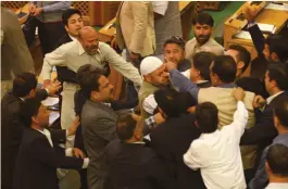  ??  ?? Independen­t MLA Sheikh Abdur Rashid shouts after being thrashed by BJP legislator­s in the J& K Legislativ­e Assembly in Srinagar on Thursday. —