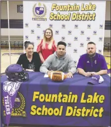  ?? The Sentinel-Record/Grace Brown ?? TIGER BACKER: Fountain Lake senior Andrew Roberson, center, signs his letter of intent Wednesday to play football at Ouachita Baptist with his family members, from left, Dru DeArmon, Buffy DeArmon and David DeArmon Wednesday.