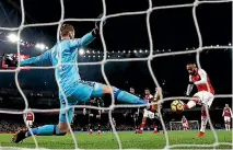  ?? PHOTOS: GETTY IMAGES ?? David De Gea can’t stop this goal from Arsenal’s Lacazette, but the Manchester United goalkeeper was in brilliant form in his team’s 3-1 win.