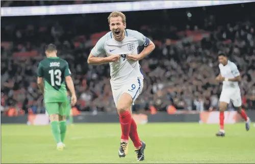  ?? PICTURE: ADAM DAVY/PA ?? HAPPY HARRY: Captain Harry Kane is jubilant as he celebrates after scoring the late goal that beat Slovenia and earned England a place in the 2018 World Cup finals.