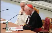  ?? ASSOCIATED PRESS FILE PHOTO ?? Pope Francis, left, listens to Cardinal Marc Ouellet’s opening address as he attends the opening of a 3-day Symposium on Vocations in the Paul VI hall at the Vatican, on Feb. 17, 2022.