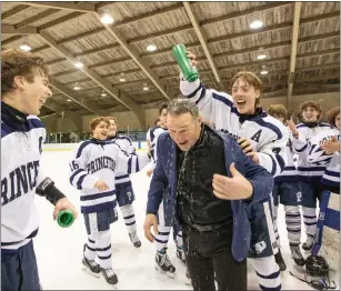  ?? RICH HUNDLEY III/ FOR THE TRENTONIAN ?? Princeton High coach Rik Johnson is doused with water after his team beat Hopewell Valley/Montgomery in overtime to win the MCT ice hockey title last Wednesday night at Mercer Rink in West Windsor.