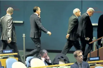  ?? SPENCER PLATT/GETTY IMAGES ?? Members of the Palestinia­n delegation leave the hall after a vote on the floor of the UN General Assembly in which the U.S. declaratio­n of Jerusalem as Israel’s capital was declared “null and void” on Thursday.