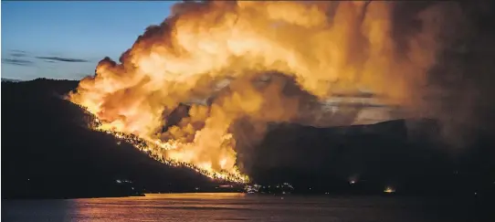  ?? SHAWN TALBOT PHOTOGRAPH­Y ?? Flames from a wildfire in July close in on Kelowna, B.C. Drones can give fire crews real-time data on fire size, growth, behaviour, fuels and hot spots.