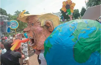  ??  ?? A protestor wears a mask of US President Donald Trump in front of the White House during the People’s Climate March in Washington, DC, on Sunday. Thousands of people across the US marched to demand action on climate change. — AFP