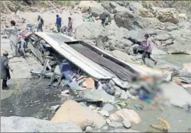  ?? PTI PHOTO ?? Rescue work takes place after a bus rolled down in Tons river in Nerwa near Chaupal, Himachal Pradesh on Wednesday.