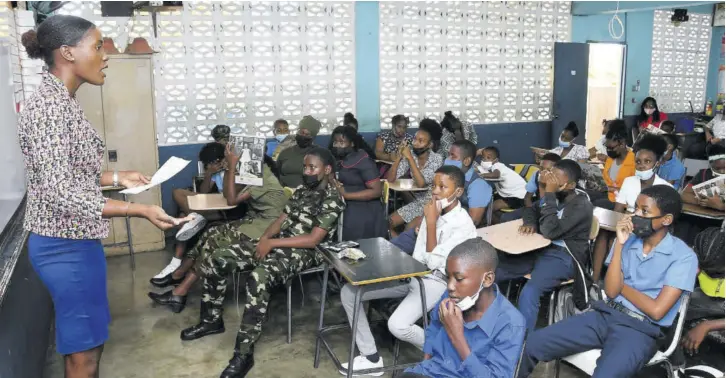  ?? ?? Jamaica Observer journalist Brittny Hutchinson tells about her job during Career Day at Allman Town Primary School in Kingston on Thursday.