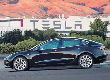  ?? Tesla ?? THE MODEL 3 is central to Tesla’s future. The electric car has a base price of $35,000. About 30 have been made, and the company plans to turn them out by the hundreds of thousands in 2018.