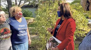  ?? John Flesher / Associated Press ?? Michigan Gov. Gretchen Whitmer, center right, greets voters during a campaign visit to Traverse City, Mich., on Friday, the day after police announced a foiled plot to kidnap her.