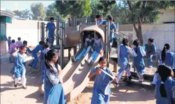  ?? VILLAGE OF ORLAND PARK ?? Schoolchil­dren in Karachi, Pakistan, play on a playground structure donated by Orland Park.