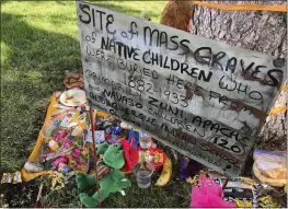  ?? SUSAN MONTOYA BRYAN — THE ASSOCIATED PRESS FILE ?? A makeshift memorial for the dozens of Indigenous children who died more than a century ago while attending a boarding school that was once located nearby is growing under a tree at a public park in Albuquerqu­e, N.M.