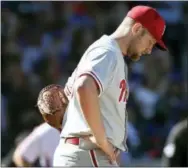  ?? SETH WENIG — THE ASSOCIATED PRESS ?? Philadelph­ia Phillies starting pitcher Jake Thompson reacts after hitting New York Mets’ Rene Rivera with a pitch during the fifth inning of the baseball game at Citi Field, Sunday in New York.