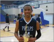  ?? THOMAS NASH — DIGITAL FIRST MEDIA ?? Phelps School junior Jailen Jamison smiles with the trophy after the Lions captured the Tri-County League title against Perkiomen School on Thursday.