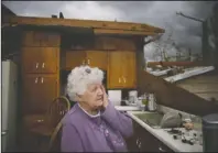  ?? The Associated Press ?? ROOFLESS: Emma Pritchett wipes a tear away in her roofless kitchen the day after a tornado hit, Monday, in Chatsworth, Ga. Severe weather has swept across the South, killing multiple people and damaging hundreds of homes from Louisiana into the Appalachia­n Mountains. Many people spent part of the night early Monday sheltering in basements, closets and bathroom tubs as sirens wailed to warn of possible tornadoes.