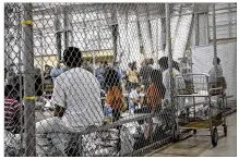  ?? U.S. CUSTOMS AND BORDER PROTECTION’S RIO GRANDE VALLEY SECTOR / TNS ?? People who’ve been taken into custody related to cases of illegal entry into the United States sit in one of the cages at a facility in McAllen on June 17. Federal authoritie­s are working to reunite families.