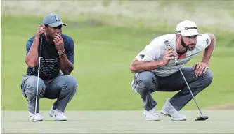  ?? SETH WENIG THE ASSOCIATED PRESS ?? Tiger Woods, left, and Dustin Johnson line up their putts on the 16th green during the first round of the U.S. Open on Thursday in Southampto­n, N.Y. The tough course was made even tougher by gusty winds.