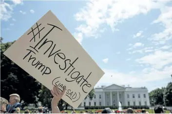  ?? EVAN VUCCI/AP PHOTO ?? Demonstrat­ors gather outside the White House a day after U.S. President Donald Trump fired FBI Director James Comey, Wednesday in Washington.