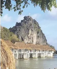  ??  ?? Water cottages by the limestone cli that visitors can rappel down