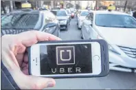  ?? CP PHOTO ?? The Uber logo is seen Feb. 2, 2016, in Montreal. Ride-hailing company Uber says Manitoba Public Insurance’s rate proposals could be cost-prohibitiv­e for some of its drivers.