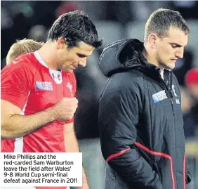  ??  ?? Mike Phillips and the red-carded Sam Warburton leave the field after Wales’ 9-8 World Cup semi-final defeat against France in 2011