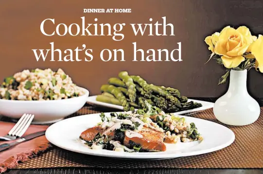  ?? ABEL URIBE/CHICAGO TRIBUNE PHOTOS; SHANNON KINSELLA/FOOD STYLING ?? Frozen salmon fillets are quickly sauteed in a skillet, then paired with an herb butter and served with farro, a type of wheat high in protein and fiber.