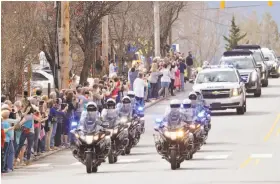  ?? John D. Simmons / Charlotte (N.C.) Observer ?? Mourners line the route through Black Mountain, N.C., as the motorcade carrying the Rev. Billy Graham passes on its way to his library in Charlotte.