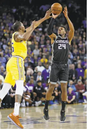  ?? Scott Strazzante / The Chronicle ?? Sacramento guard Buddy Hield hits a 3-pointer in the final minute of the Warriors’ 125-123 win at Oracle Arena. He finished with 19 points.