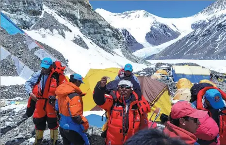  ?? LHAPA / XINHUA ?? Members of a Chinese team set out from a camp at an altitude of 6,500 meters on Mount Qomolangma in the Tibet autonomous region on Sunday. They are scheduled to reach the summit of the world’s highest mountain on Wednesday.