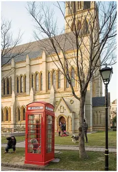  ?? ?? Eerie: A red telephone box outside a church with traditiona­l English spire in Shanghai’s ‘Thames Town’