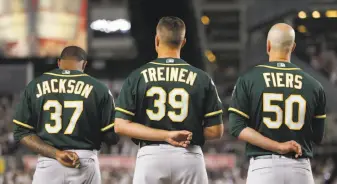  ?? Alex Trautwig / MLB Photos via Getty Images ?? Edwin Jackson, Blake Treinen and Mike Fiers stand during the national anthem. Jackson was on the A’s roster Wednesday. Fiers, a fellow starter, was not one of the 25 men on the roster.