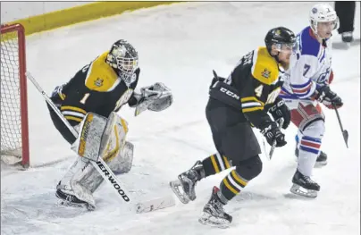  ?? JASON SIMMONDS/JOURNAL PIONEER ?? Summerside D. Alex MacDonald Ford Western Capitals forward Austin Taylor looks to screen Campbellto­n Tigers goaltender Greg Maggio while battling for position with defenceman Jabes Benedict during first-period action at Eastlink Arena on Monday night....