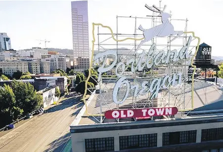  ?? JUSTIN KATIGBAK ?? The landmark Portland, Oregon, sign welcomes visitors to the city’s downtown.