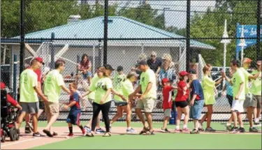  ?? KRISTI GARABRANDT — THE NEWS-HERALD ?? The Miracle League of Lake County kicked off its inaugural season July 28 with a dedication ceremony for the Lake Health Miracle Park and Lubrizol Miracle Playground located at Classic Park in Eastlake.