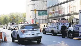  ?? MARK LENNIHAN/ASSOCIATED PRESS ?? Police block off several streets near Columbus Circle on Thursday in NewYork. Police negotiator­s talked to a man barricaded inside a vehicle who eventually gave himself up.