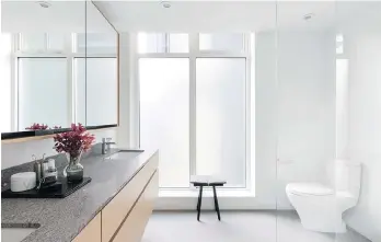  ??  ?? Bathrooms feature white, frosted floor-to-ceiling glass, and heated porcelain tiles with programmab­le thermostat.