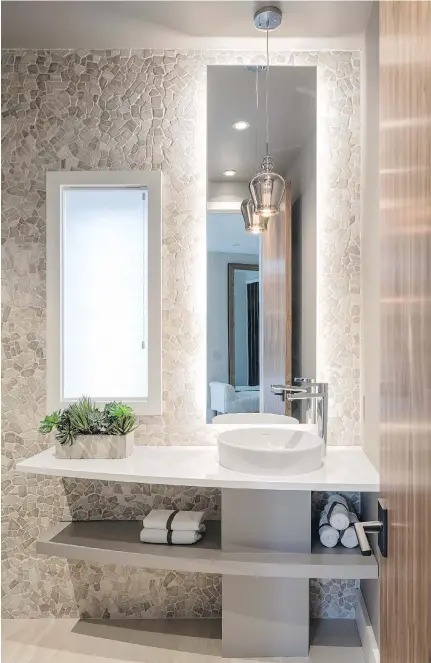  ??  ?? A warm palette, intriguing textures and natural finishes make for a welcoming space that pops in this powder room by Astro Design Centre, one of the finalists in the 2016 Housing Design Awards. Bathroom and kitchen renovation­s were popular, and many...