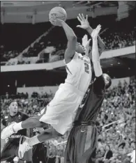  ?? Arkansas Democrat-Gazette/MELISSA SUE GERRITS ?? Arkansas forward Alandise Harris attempts a layup against South Alabama’s Austin Karazsia on Saturday night.