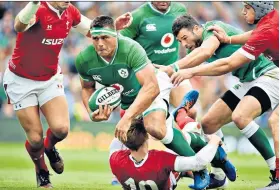  ??  ?? Driving force: Ireland’s CJ Stander powers past Rhys Patchell, who had to go off