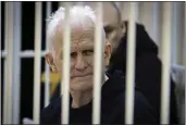  ?? VITALY PIVOVARCHY­K — BELTA POOL PHOTO VIA AP, FILE ?? Ales Bialiatski, the head of Belarusian Vyasna rights group, sits in a defendants' cage during a court session in Minsk, Belarus, on Thursday.